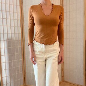 Orange brown long sleeve top with ruffle trim